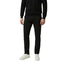 Image 1 : Pantalon chino slim Antony Morato homme noir coton stretch, vue de face portée avec pull noir et sneakers blanches — Delvale